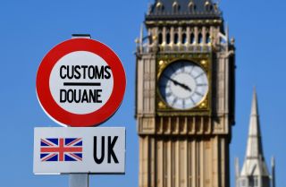 A model of a customs road sign is seen at the mock U.K.-EU border, with a mock Big Ben in the background, at the Mini-Europe theme park in Brussels, Belgium, on May 20, 2020.