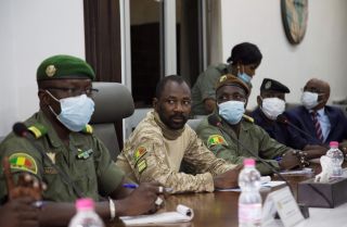 Colonel Assimi Goita (center) sits between other Malian military leaders during a meeting with an Economic Community of West African States (ECOWAS) delegation on Aug. 22, 2020. Goita seized power for the second time in a May 2021 coup.