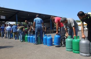 People wait to fill up fuel tanks in the southern Lebanese city of Sidon on Aug. 10, 2021. People wait to fill up fuel tanks in the southern Lebanese city of Sidon on Aug. 10, 2021.