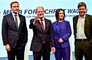 FDP leader Christian Lindner, SPD leader Olaf Scholz and the co-leaders of Germany's Greens party Annalena Baerbock and Robert Habeck (left to right) pose during a press conference in Berlin after presenting their coalition agreement on Nov. 24, 2021. 