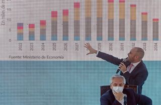 Argentine President Alberto Fernandez listens as the country’s finance minister explains the proposed payment to the International Monetary Fund (IMF) for the debt restructuring during a meeting with government officials and businessmen in Buenos Aires, Argentina, on Jan. 5, 2022. 