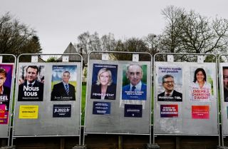 A photo shows presidential candidates' election posters on a billboard in La Baussaine, western France, on March 29, 2022. A photo shows presidential candidates' election posters on a billboard in La Baussaine, western France, on March 29, 2022.
