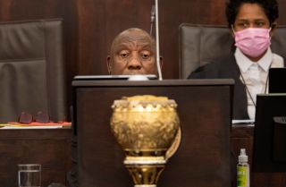 South African President Cyril Ramaphosa waits for heckling to die down as he makes a speech in parliament on June 9, 2022. Ramaphosa claimed he was the victim of "dirty tricks" in a damaging burglary scandal. 