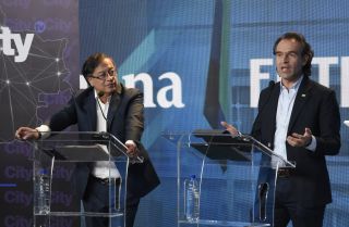 Centrist candidate Federico Gutierrez (right) speaks next to left-wing candidate Gustavo Petro (left) in Bogota on May 23, 2022, during the last presidential debate before Colombians begin casting ballots to elect their next leader. 