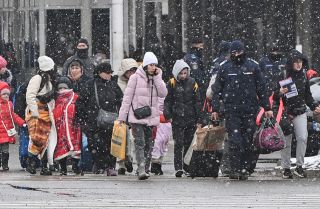 Refugees from Ukraine walk at the Ukrainian-Romanian border in Siret on March 2, 2022. Though the war is creating significant social and security challenges for Romania that EU assistance will only partially mitigate, it is also leading to temporary political stability. Refugees from Ukraine walk at the Ukrainian-Romanian border in Siret on March 2, 2022.