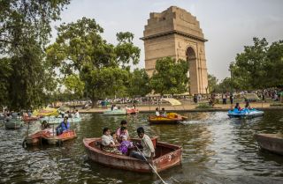 Families in New Dehli take a boat ride during a heat wave. 
