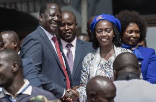 Raila Odinga (center left) shakes the hand of his newly announced running mate, Martha Karua, (center right), on May 16, 2022, in the Kenyan capital of Nairobi.