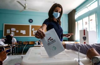 A voter casts her ballot in Lebanon's May 15, 2022, parliamentary election at a polling station in the southern suburbs of Beirut.