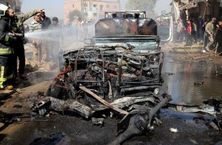 A vehicle destroyed in a bombing is seen in Syria's rebel-held northern city of Afrin on Oct. 11, 2021. A vehicle destroyed in a bombing is seen in Syria's rebel-held northern city of Afrin on Oct. 11, 2021.