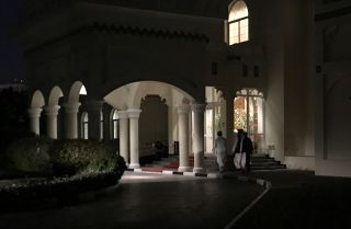 Members of the Taliban negotiating team enter the venue in Doha