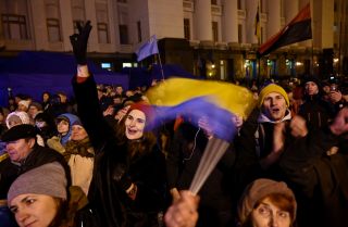 People gather outside the presidential office in Kyiv on Dec. 9, 2019, as they wait for news of talks held in Paris to try to end the conflict in eastern Ukraine.