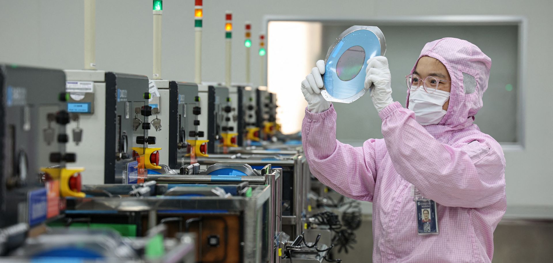 This photo taken on Dec. 25, 2024, shows an employee producing semiconductor chips for export at a factory in Binzhou, a city in China's eastern Shandong province.