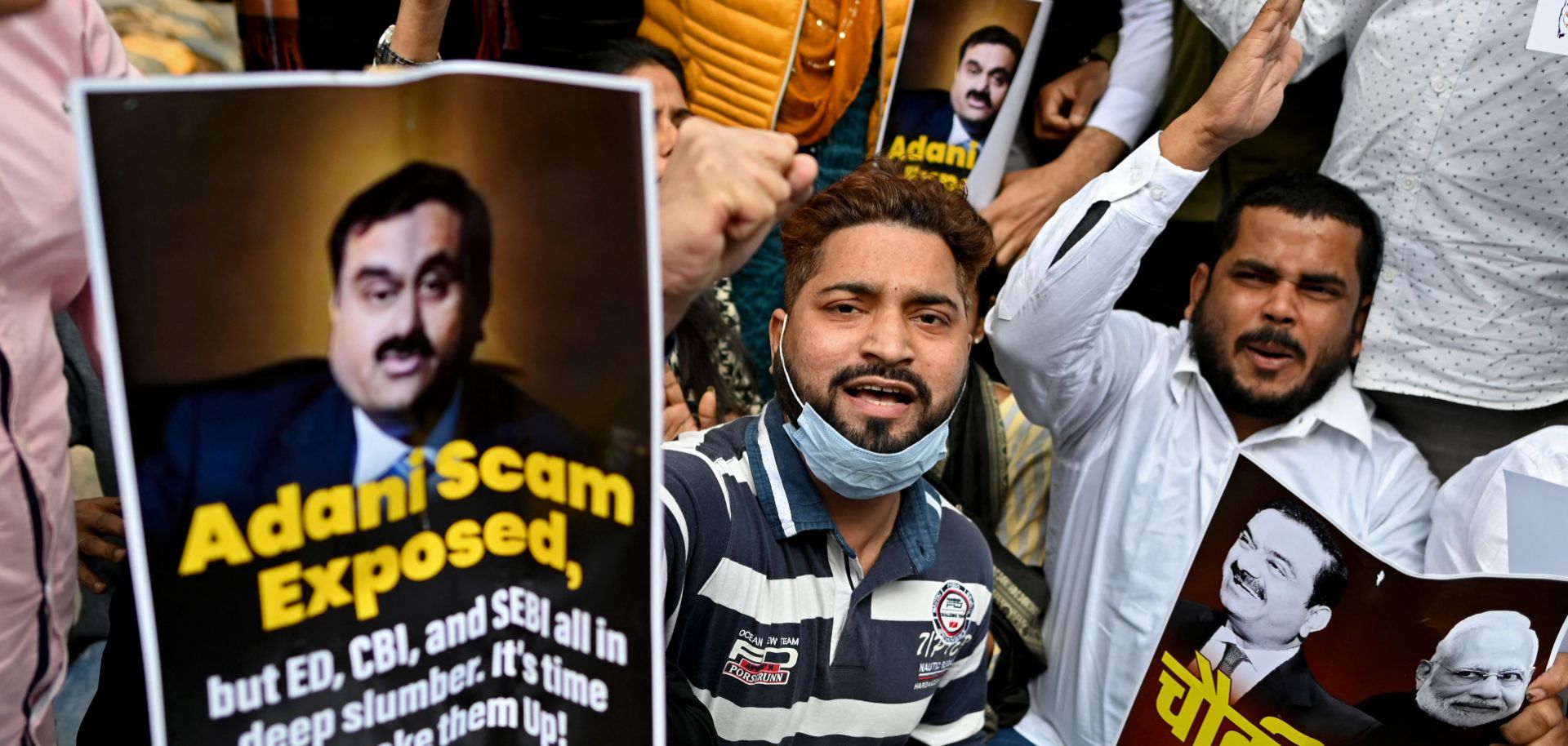 Activists who are part of the youth wing of the opposition Indian National Congress party hold placards and shout slogans during a protest outside the regional headquarters of India's Life Insurance Corporation in New Delhi, India, on Feb. 7, 2023. The protesters are calling for an inquiry into allegations of major accounting fraud at the Adani Group.