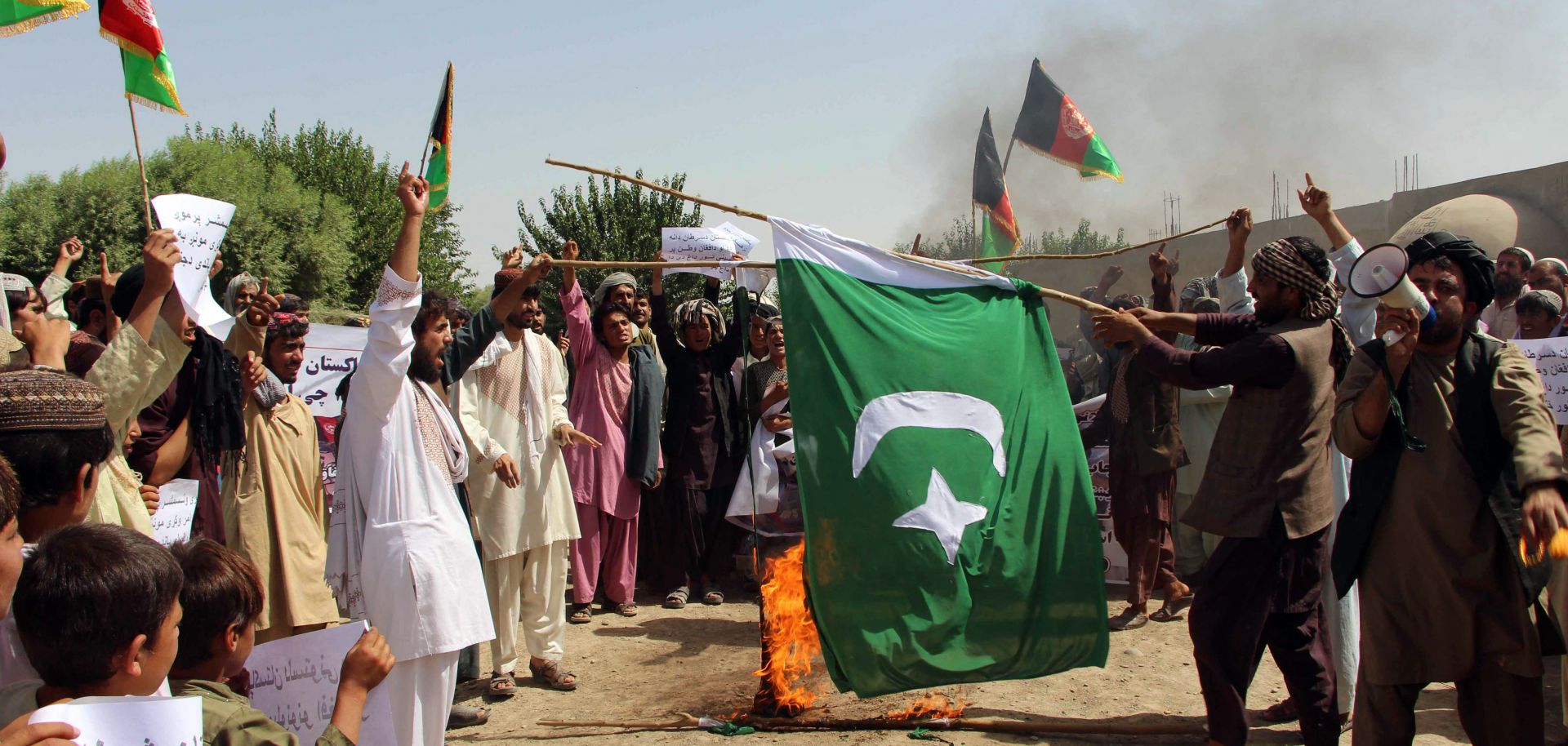Afghan protesters burn a Pakistani flag during a demonstration in Helmand Province in 2016.