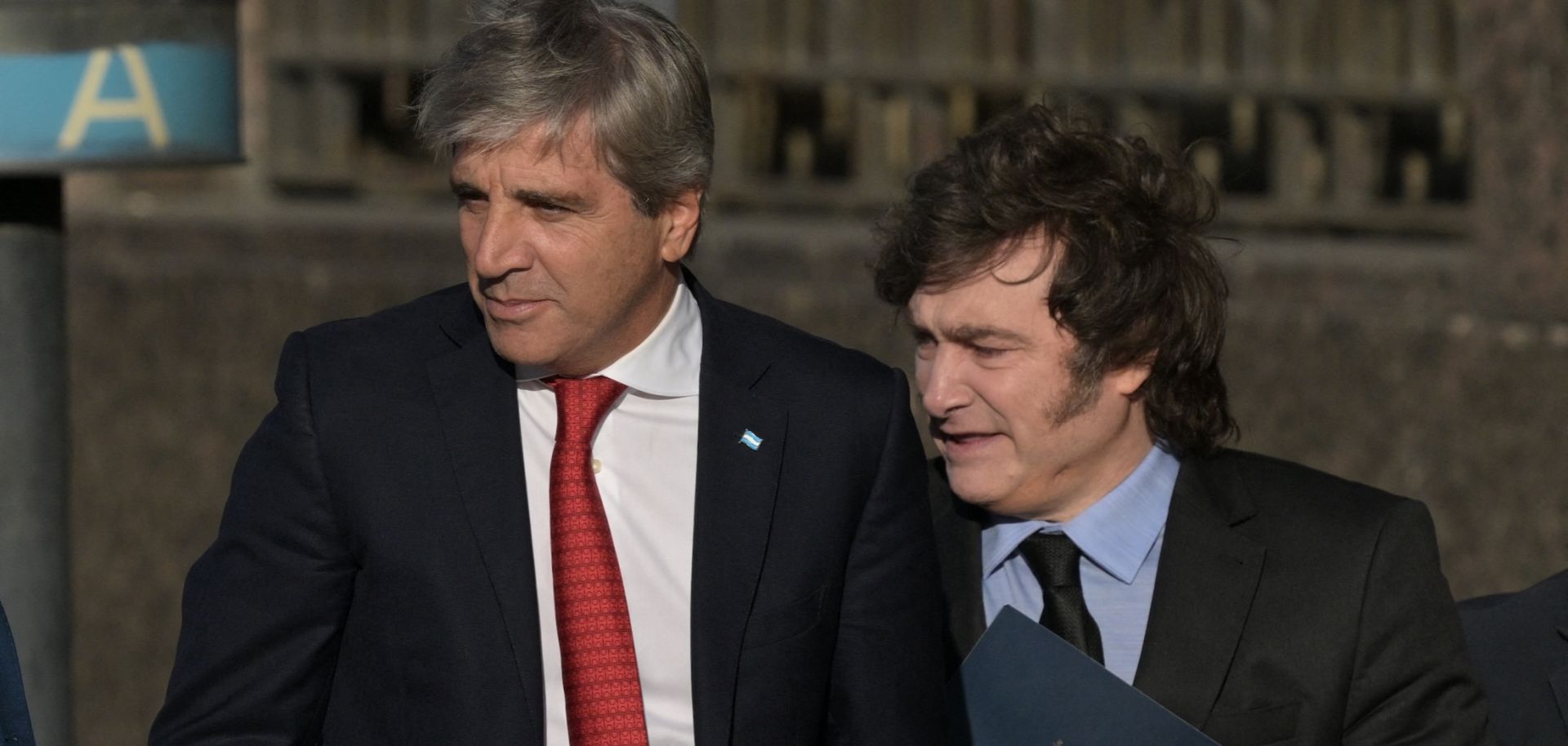 Argentina's economy minister Luis Caputo (L) and Argentine President Javier Milei walk from the Casa Rosada Presidential Palace after a meeting on April 14, 2025.