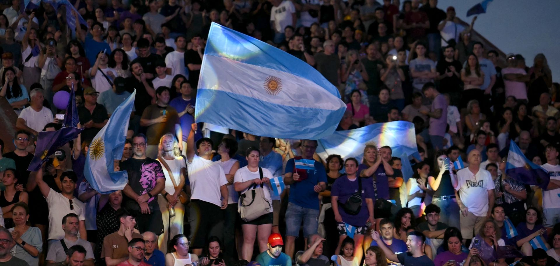Supporters of Argentine President Javier Milei's Liberty Advances (LLA) party wave flags during a campaign rally in Rosario, Argentina, on Oct. 23, 2025.