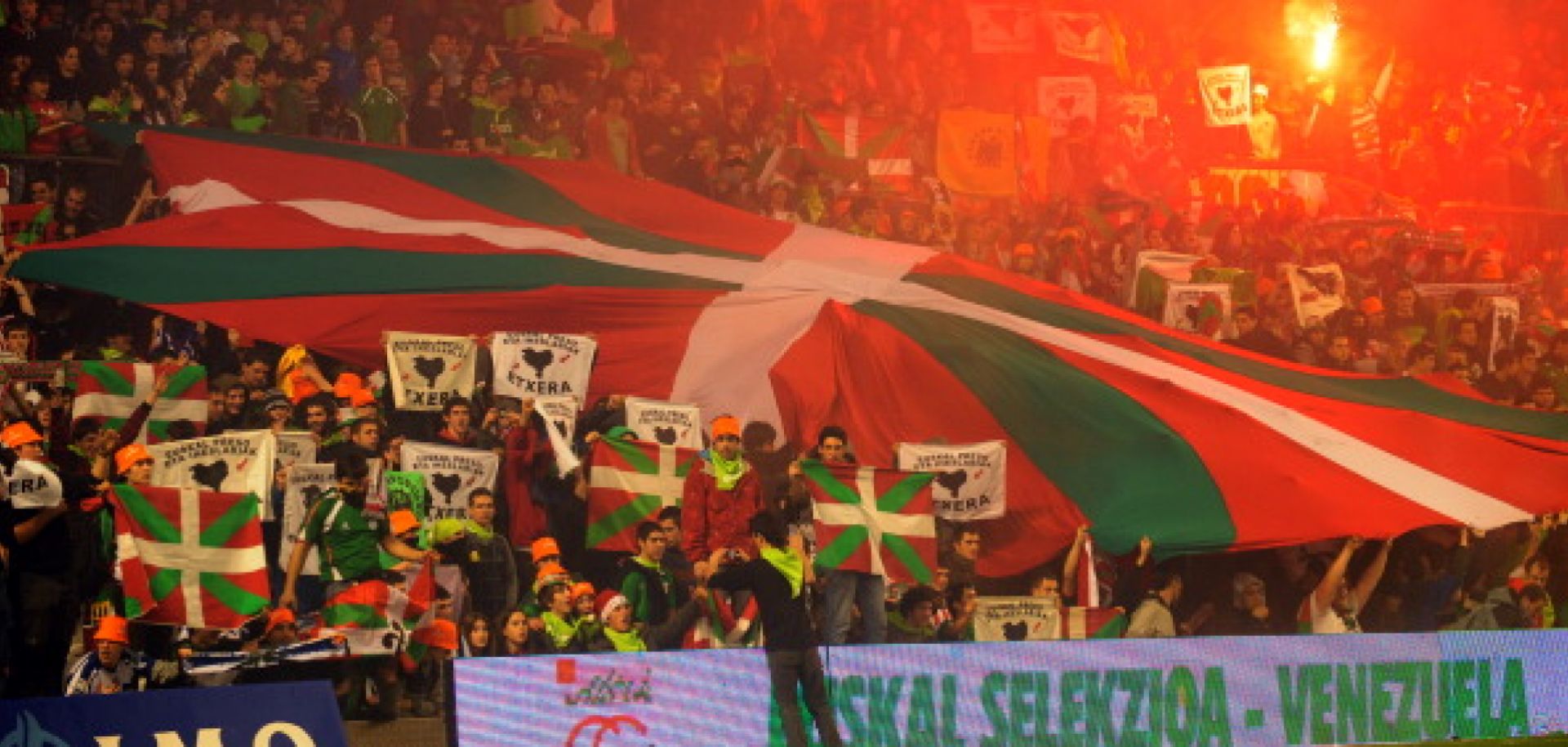 Basque team supporters unfurl an Ikurrina, the region's flag, during a friendly soccer match between the team and the Venezuelan national team in 2010.