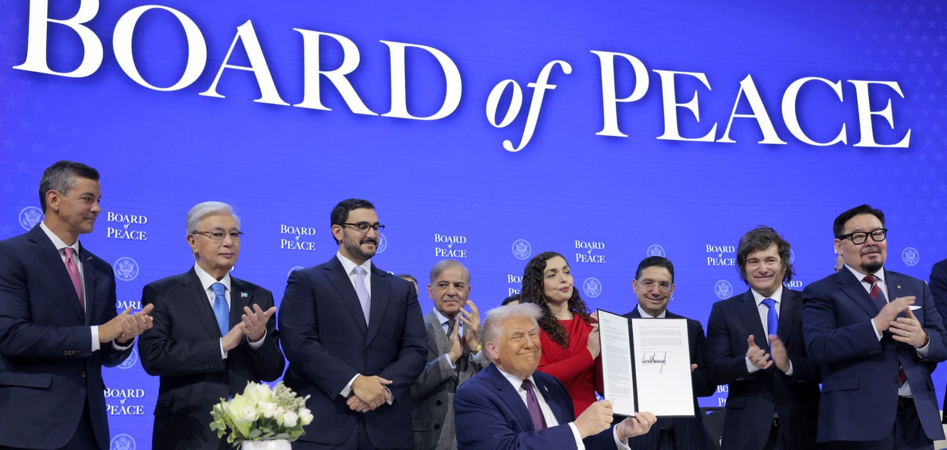 U.S. President Donald Trump (center) holds up his signature on the founding charter among world leaders during a ceremony for the Board of Peace at the World Economic Forum in Davos, Switzerland, on Jan. 22, 2026.