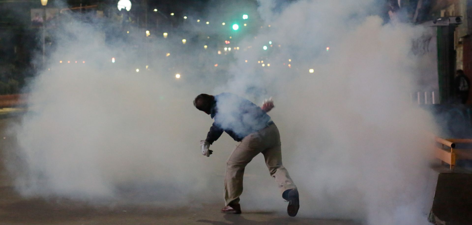A demonstrator throws a tear gas canister during a demonstration against Bolivian President Evo Morales on Nov. 5, 2019, in La Paz, Bolivia.
