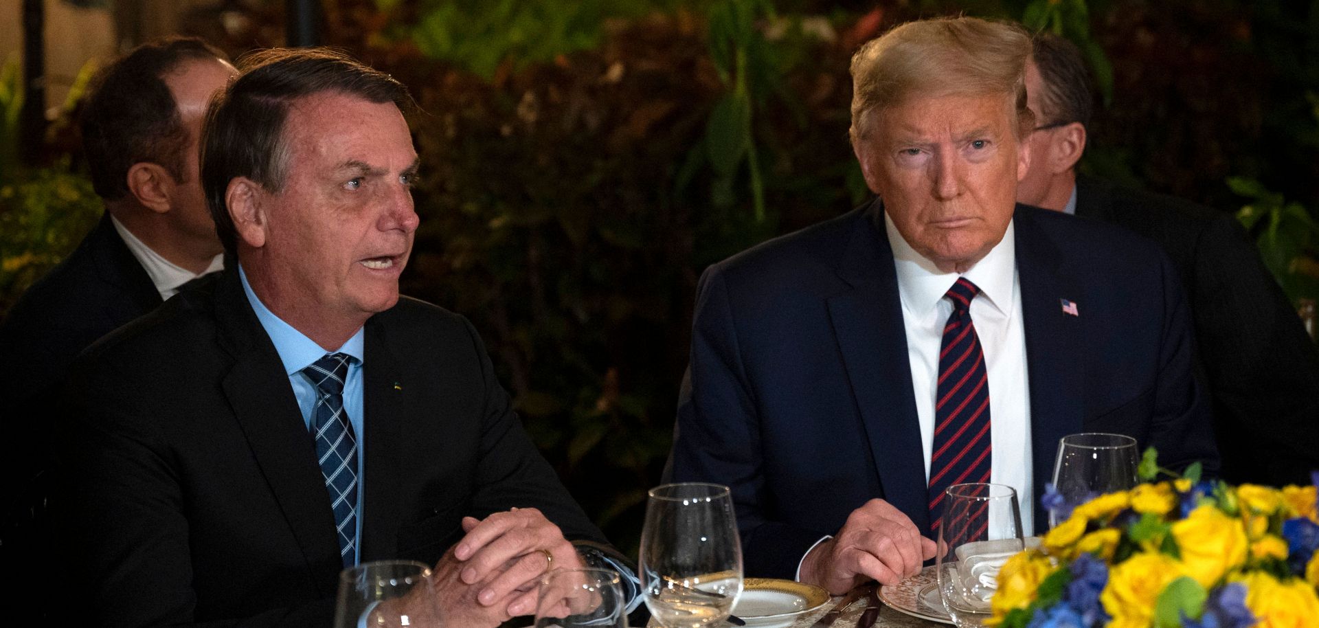 U.S. President Donald Trump (right) speaks with Brazilian President Jair Bolsonaro during a dinner at Mar-a-Lago in Palm Beach, Florida, on March 7, 2020.