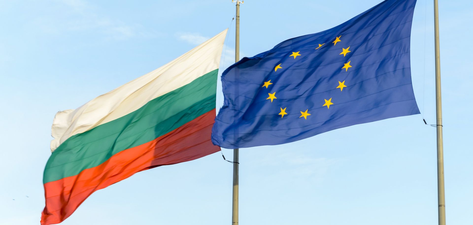 The Bulgarian flag and the European flag waving in the wind.