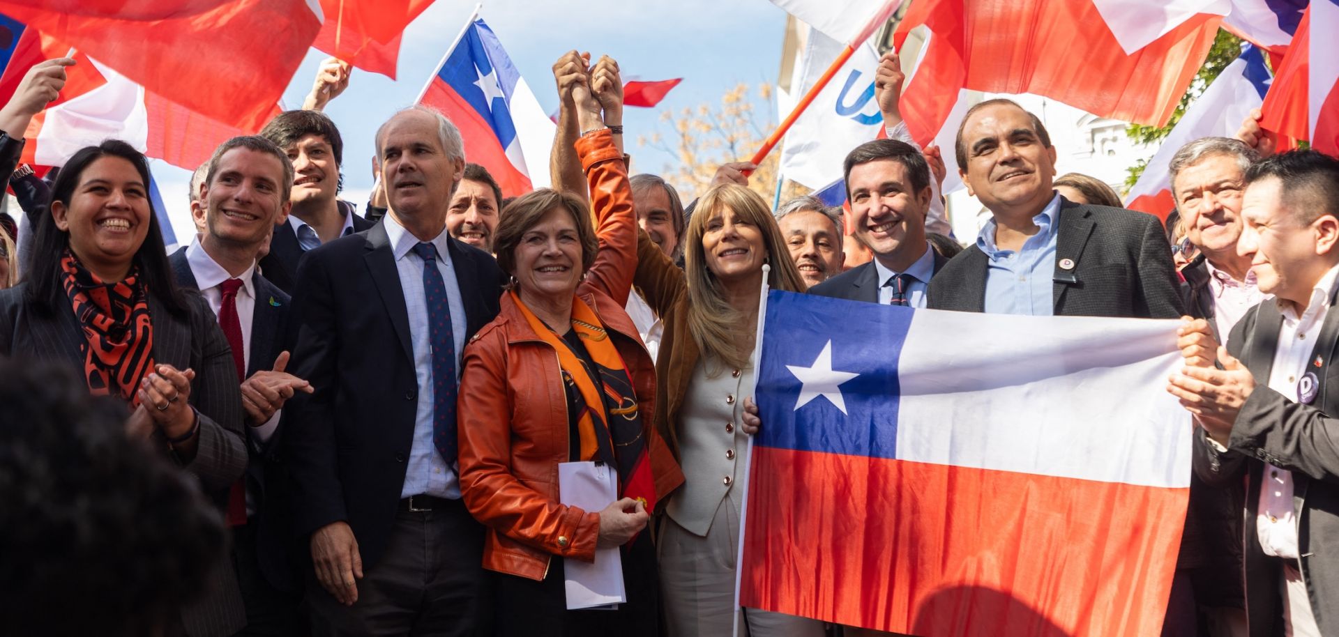 Chile's presidential candidate Evelyn Matthei (C) poses with her team after registering her candidacy at the Electoral Service of Chile in Santiago on Aug. 16, 2025.