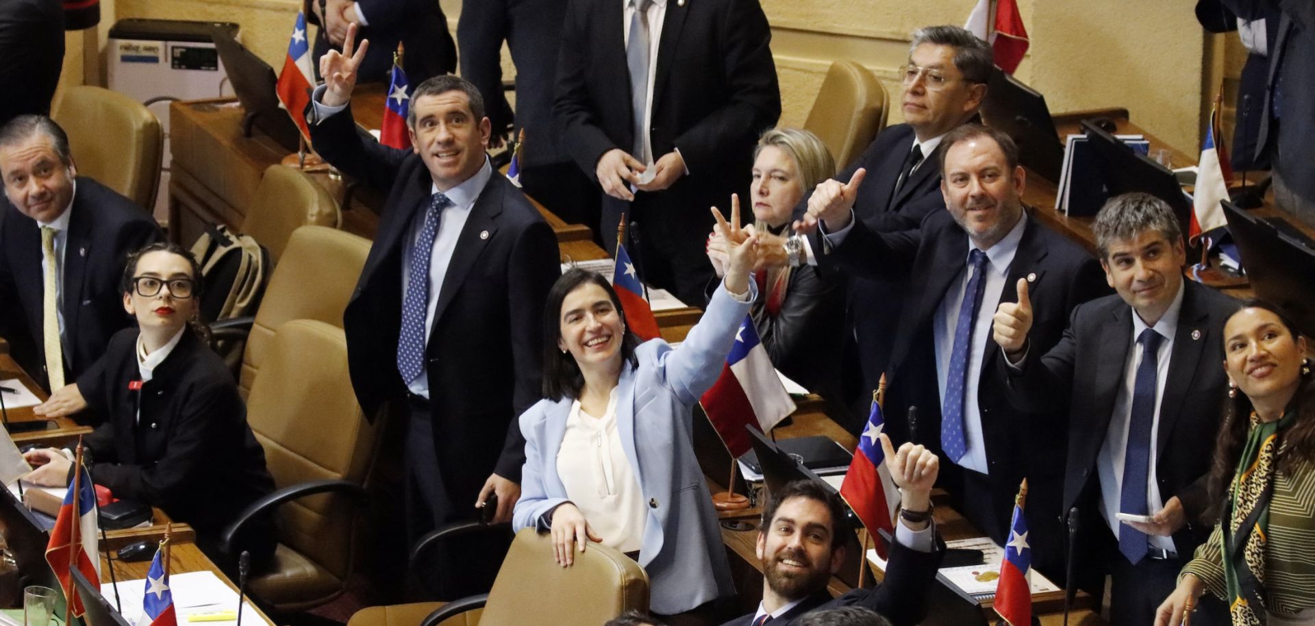 Chilean lawmakers in Congress celebrate at the end of the voting session on the economic reform bill on July 21, 2026.