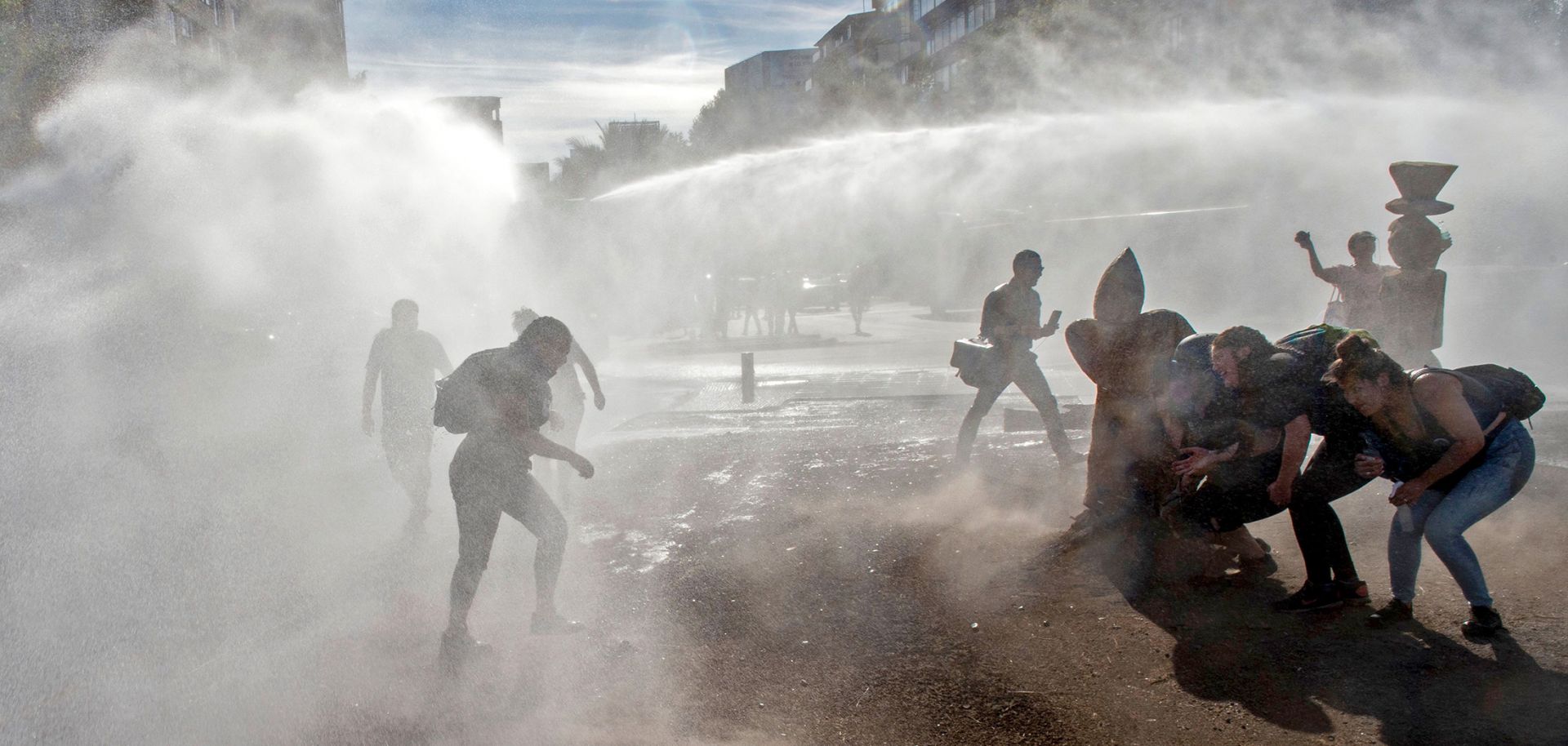 Demonstrators clash with riot police following a protest against the Chilean government Dec. 18, 2019, in Santiago, Chile.