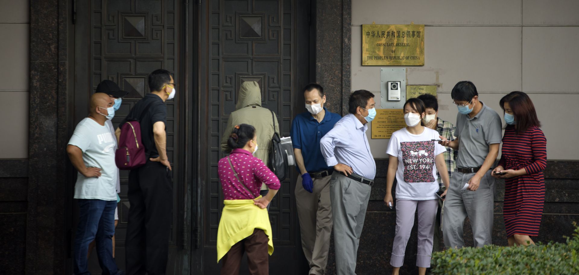 A group of people stand outside the Chinese consulate in Houston, Texas, after the United States ordered Beijing to immediately close the office on July 22, 2020.