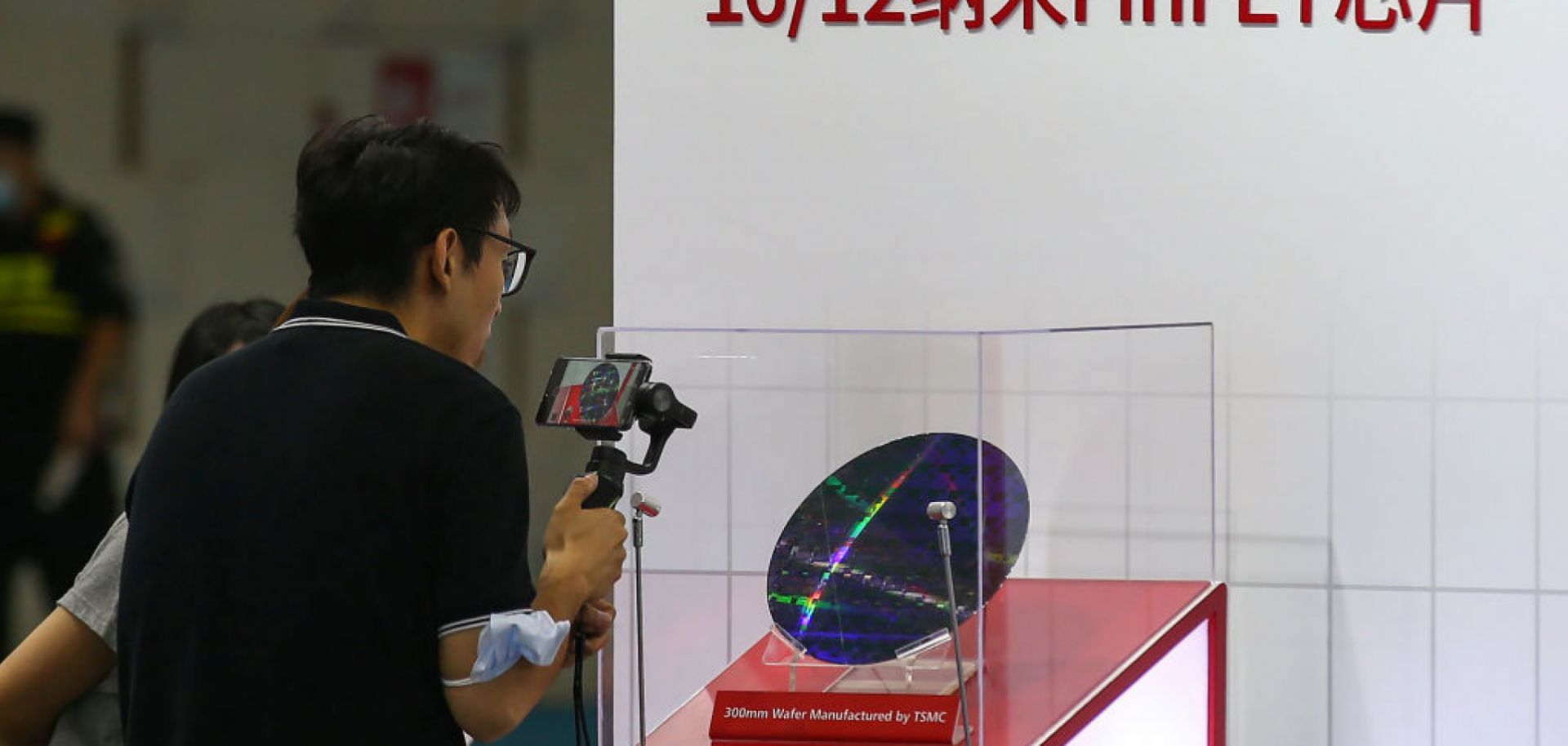 A visitor takes photos at the 2020 World Semiconductor Conference on Aug. 26, 2020, in Nanjing in China's eastern Jiangsu province of a chip made by Taiwan Semiconductor Manufacturing Co.