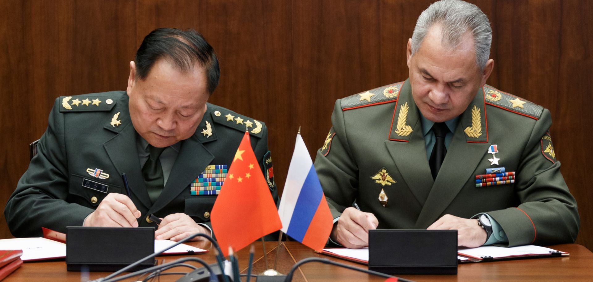 Russian Defense Minister Sergei Shoigu, right, and Zhang Youxia, vice chairman of China's Central Military Commission, sign documents boosting military ties in Moscow on Sept. 4, 2019.