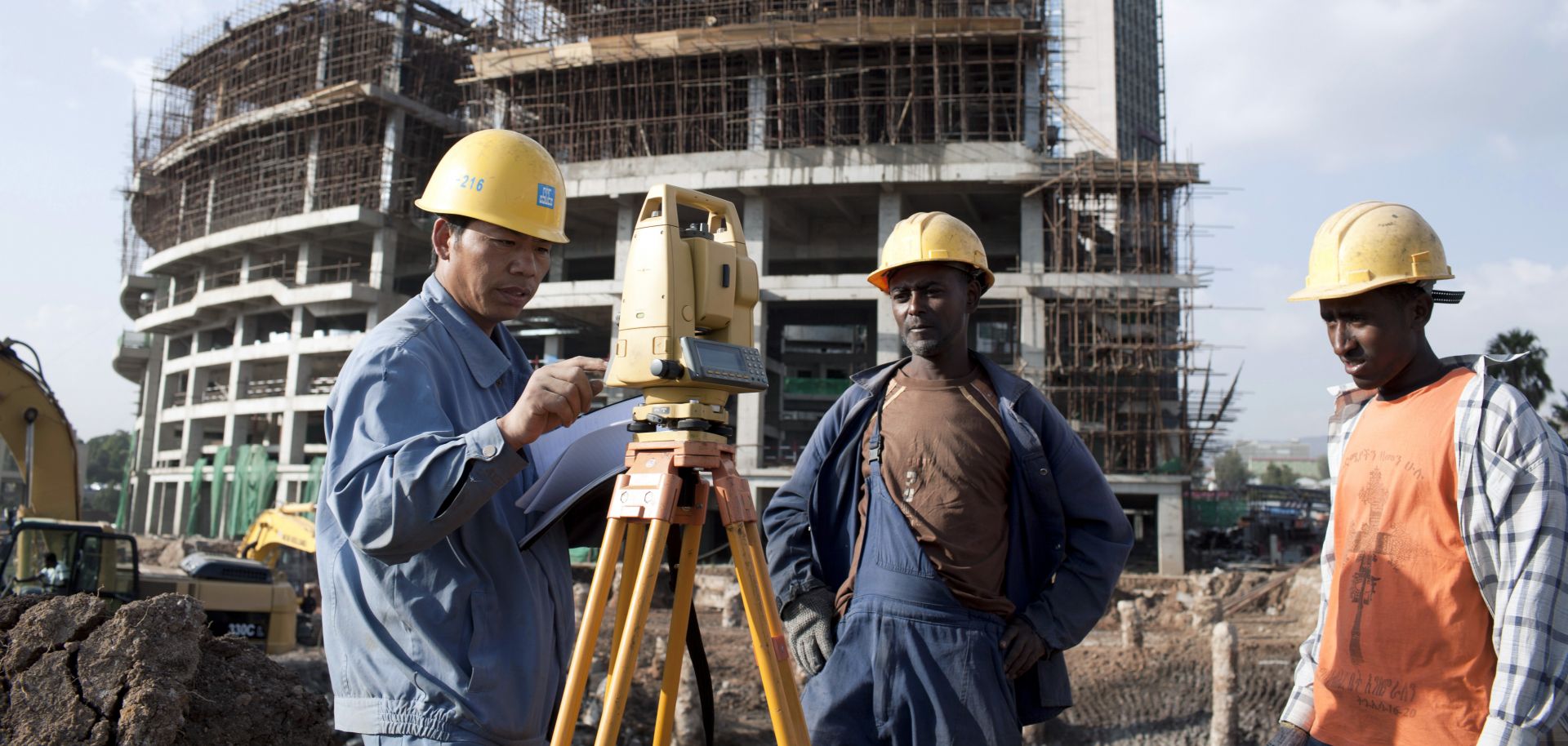 A Chinese construction worker with Ethiopian workers at the new African Union Buildings on November 17, 2010 in Addis Ababa, Ethiopia.