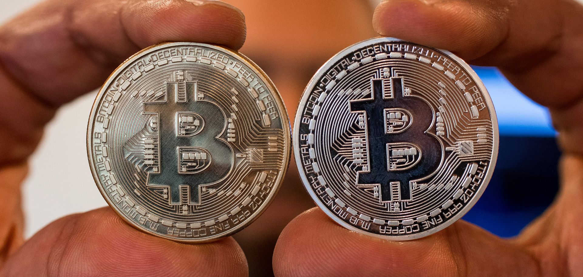 A person holds a visual representation of Bitcoin on Feb. 6, 2018, at the 'Bitcoin Change' shop in the Israeli city of Tel Aviv.