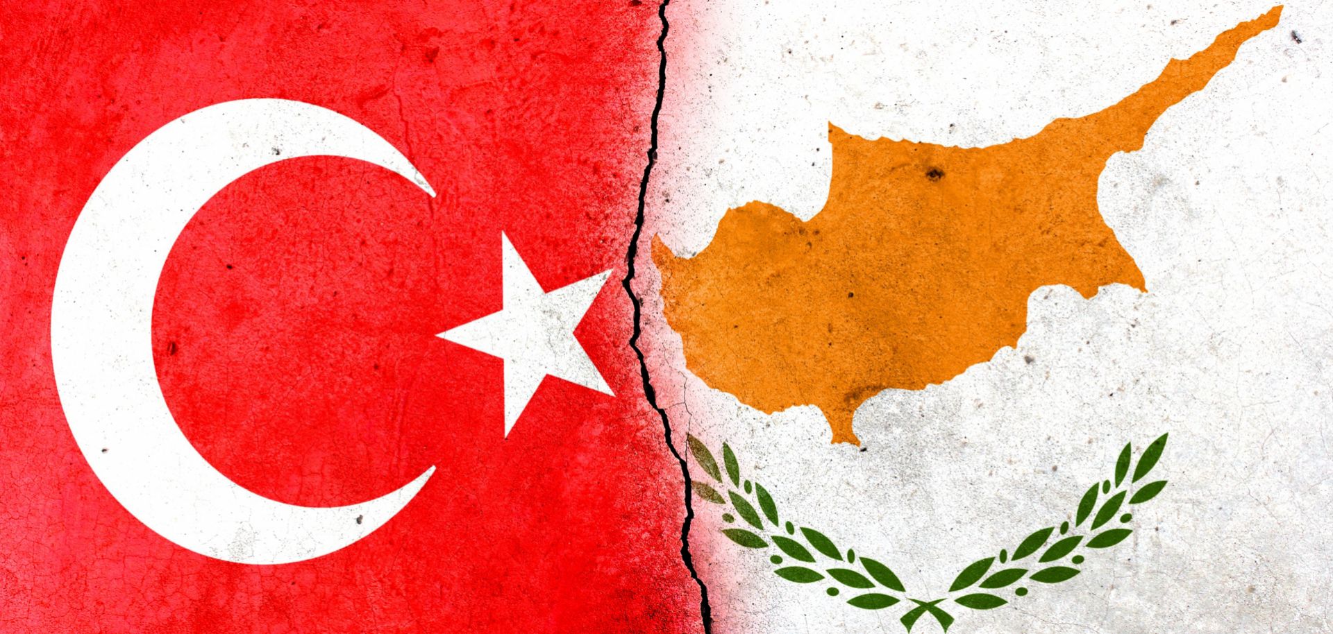 The flags of the Turkish Republic of Northern Cyprus (L) and the Republic of Cyprus (R) are divided by a crack.