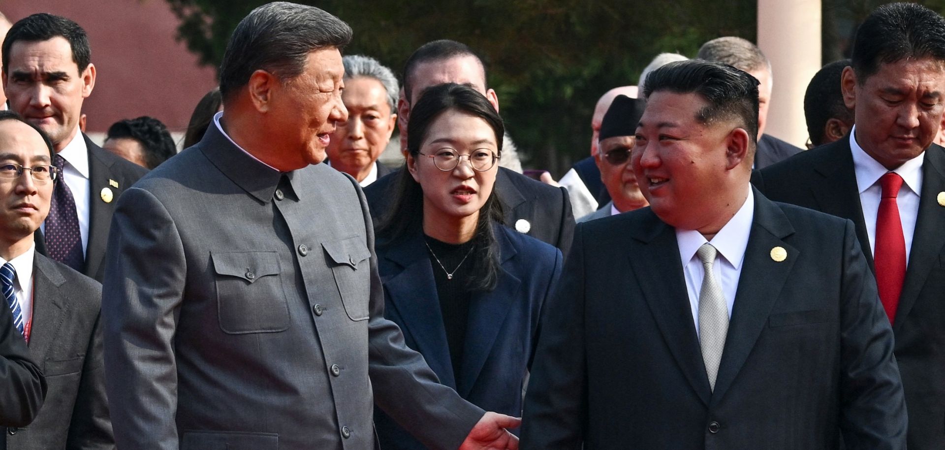 Chinese President Xi Jinping (left) gestures to North Korean leader Kim Jong Un before a military parade in Beijing's Tiananmen Square on Sept. 3, 2025.