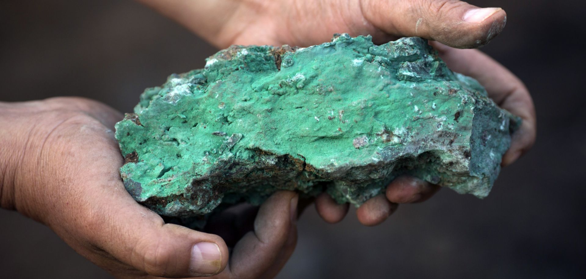 A man holds a copper-rich piece at a mine in Kolwezi, Democratic Republic of Congo, in July 2016. 