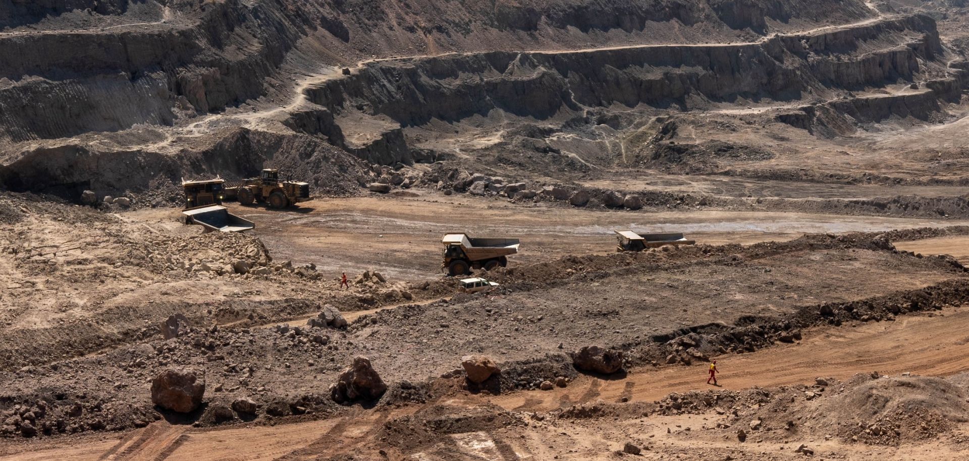 Trucks haul away ore from a pit in the Chinese-owned Tenke Fungurume Mine, one of the largest copper and cobalt mines in the world, in southeastern Democratic Republic of the Congo on June 17, 2023.