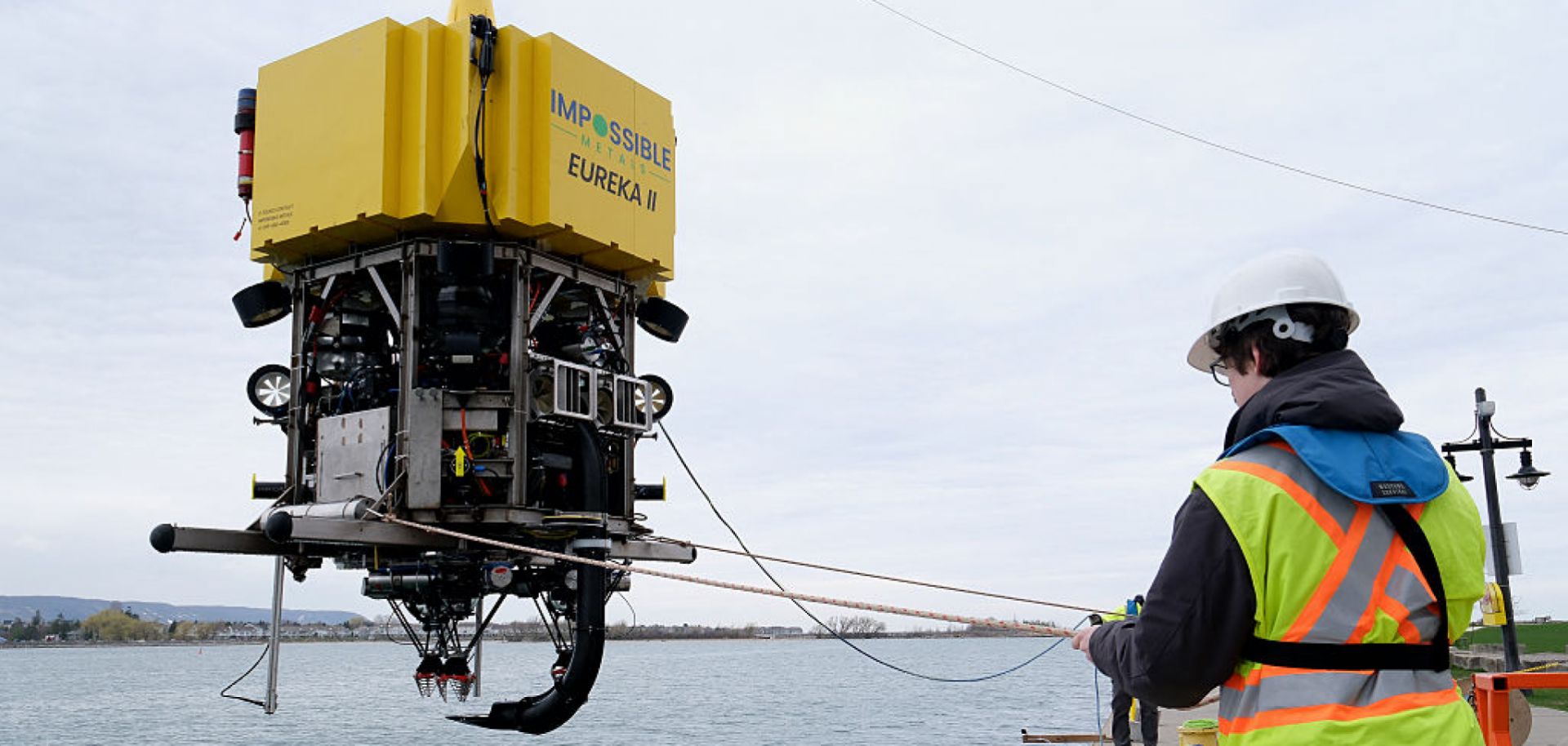 A worker positions a robotic underwater vehicle that can be remotely operated to harvest mineral deposits in the deep ocean, after conducting tests in a lake in Collingwood, Ontario, on May 1, 2025.