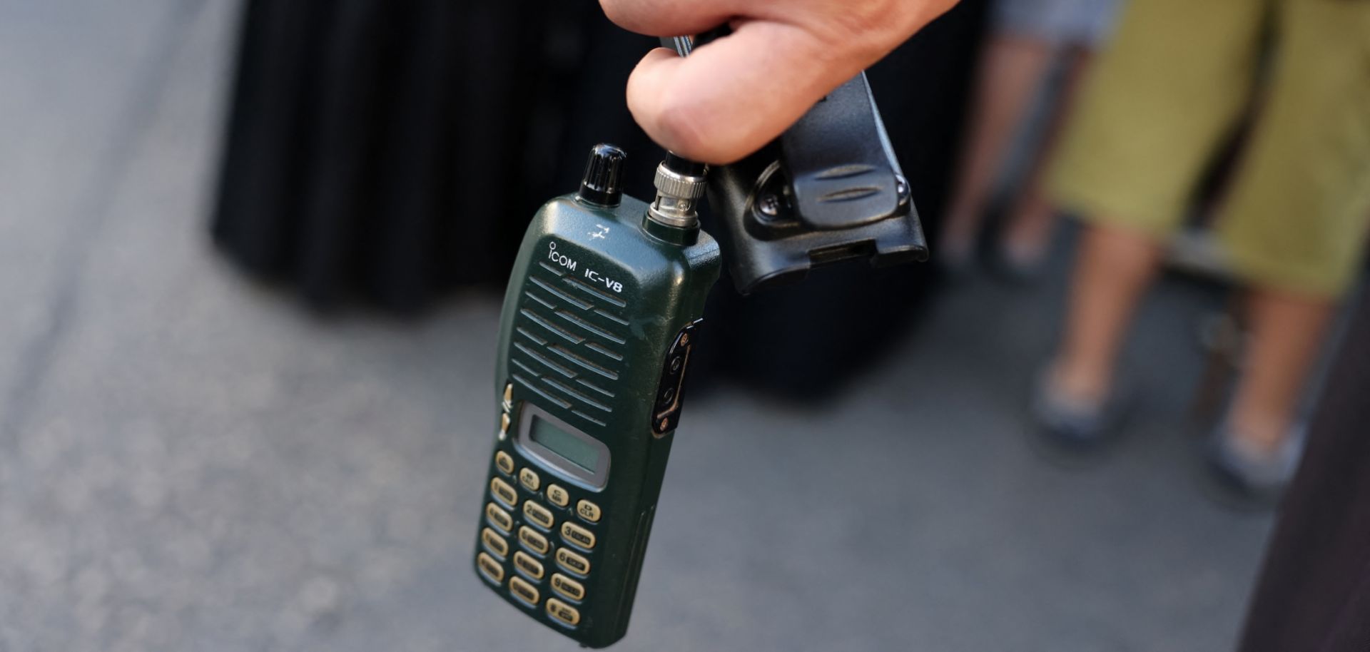 A man in Beirut, Lebanon, holds a walkie-talkie after removing its battery on Sept. 18, 2024, during a funeral for people killed when hundreds of paging devices exploded across the country the previous day. 