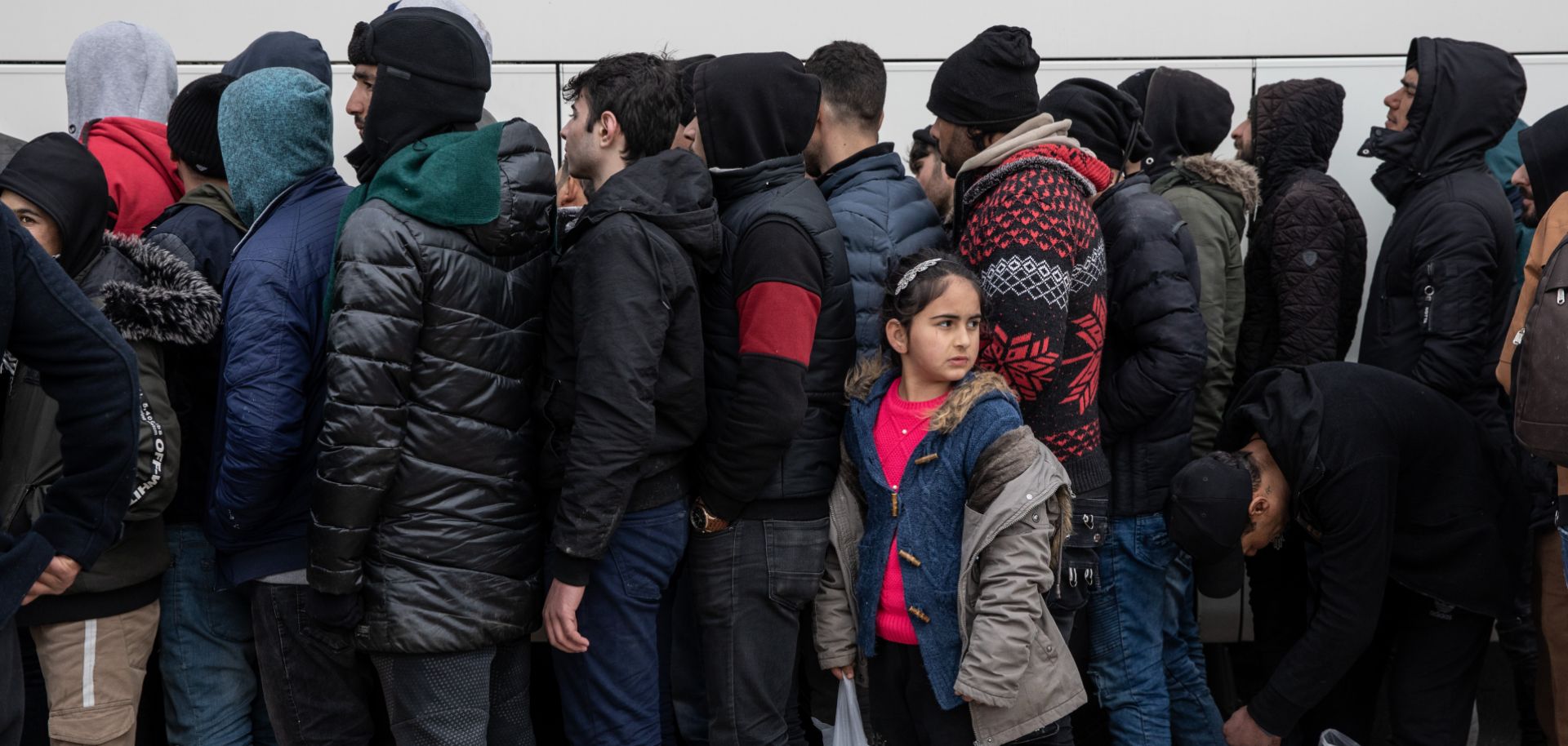 A photo of refugees and migrants waiting in line to receive blankets and food near the Greek border in Edirne, Turkey, on March 5, 2020.