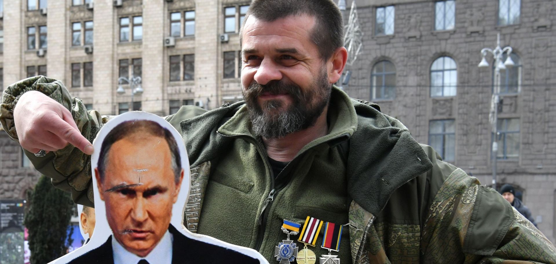 A Ukrainian veteran poses with a cardboard cutout of Russian President Vladimir Putin during a March 29, 2019, rally in Kiev against Russia and pro-Russian candidates running in the country's March 31 presidential election.