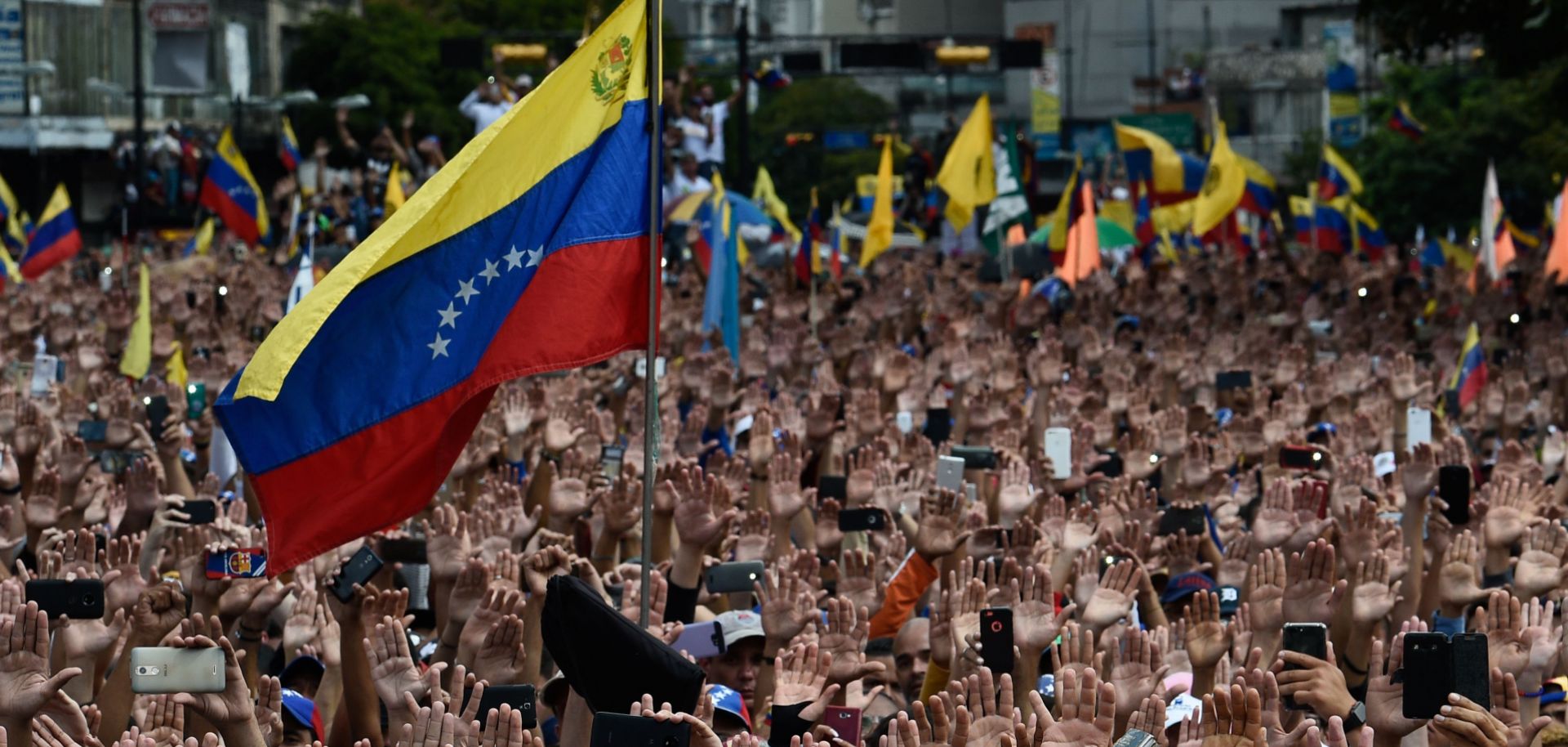 Protesters raise their hands during a rally against Venezuelan President Nicolas Maduro in Caracas on Jan. 23, 2019.
