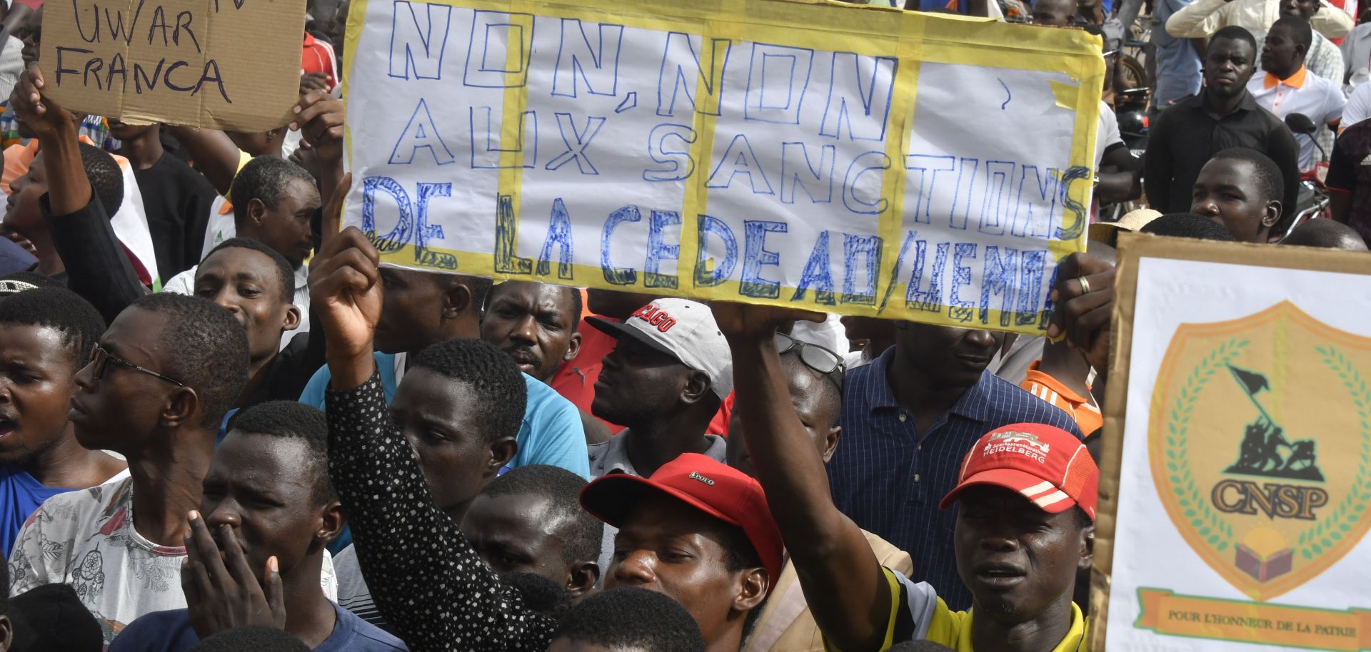 Protesters hold placards denouncing ECOWAS on Aug. 3, 2023, in Niamey, Niger.