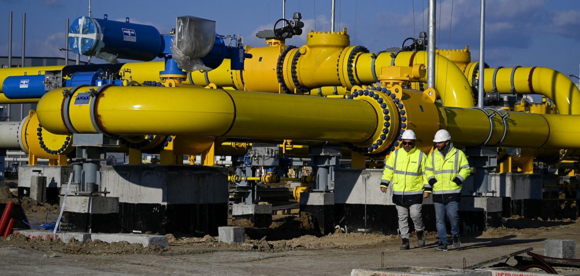 Employees walk at the construction site of a gas metering station, part of the pipeline link between Bulgaria and Greece near the village of Malko Kadievo, on March 18, 2022. 
