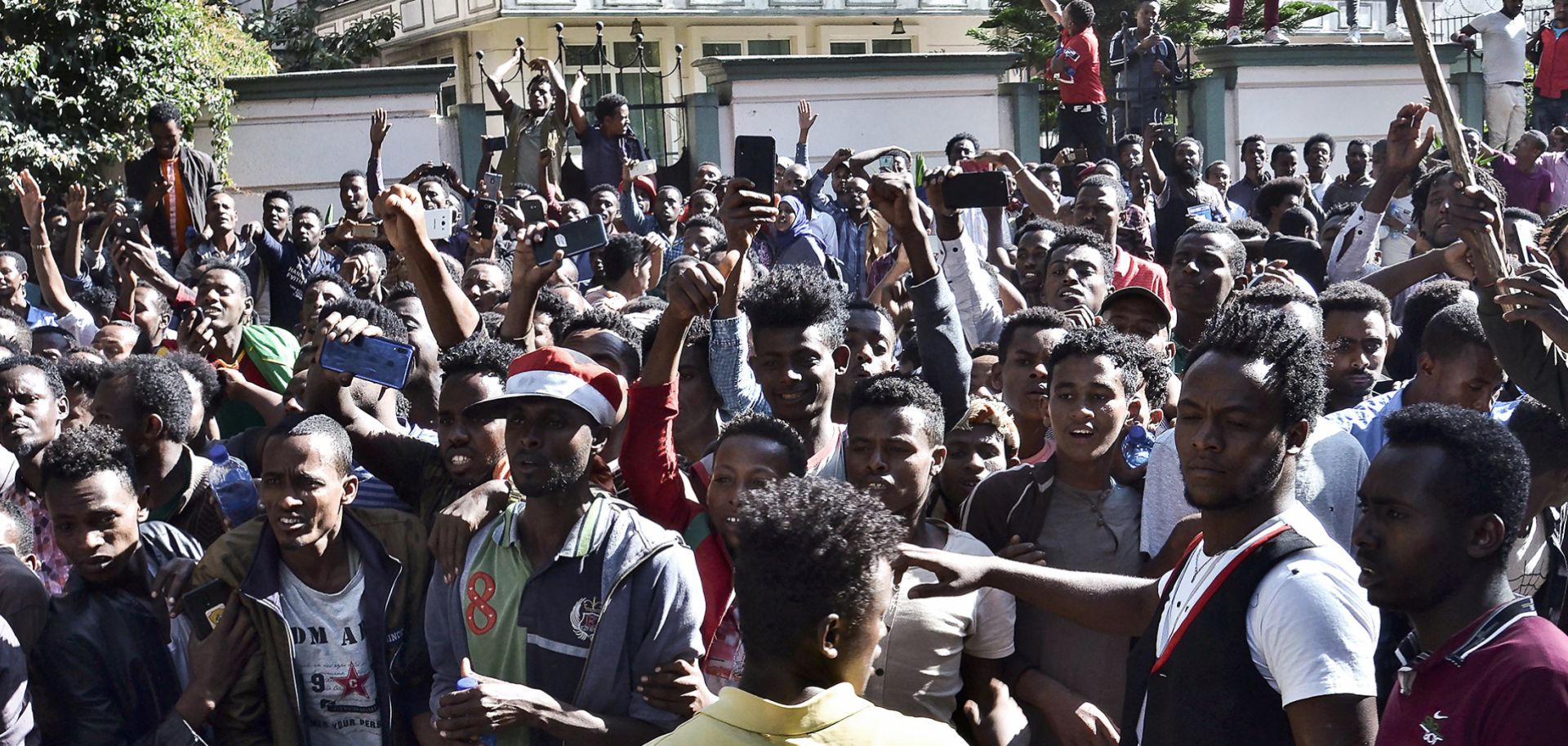 Supporters of Jawar Mohammed, a member of the Oromo ethnic group and high-profile opposition activist, gather outside Ethiopian Prime Minister Abiy Ahmed's home following rumors that his security forces had tried to orchestrate an attack against Mohammed.