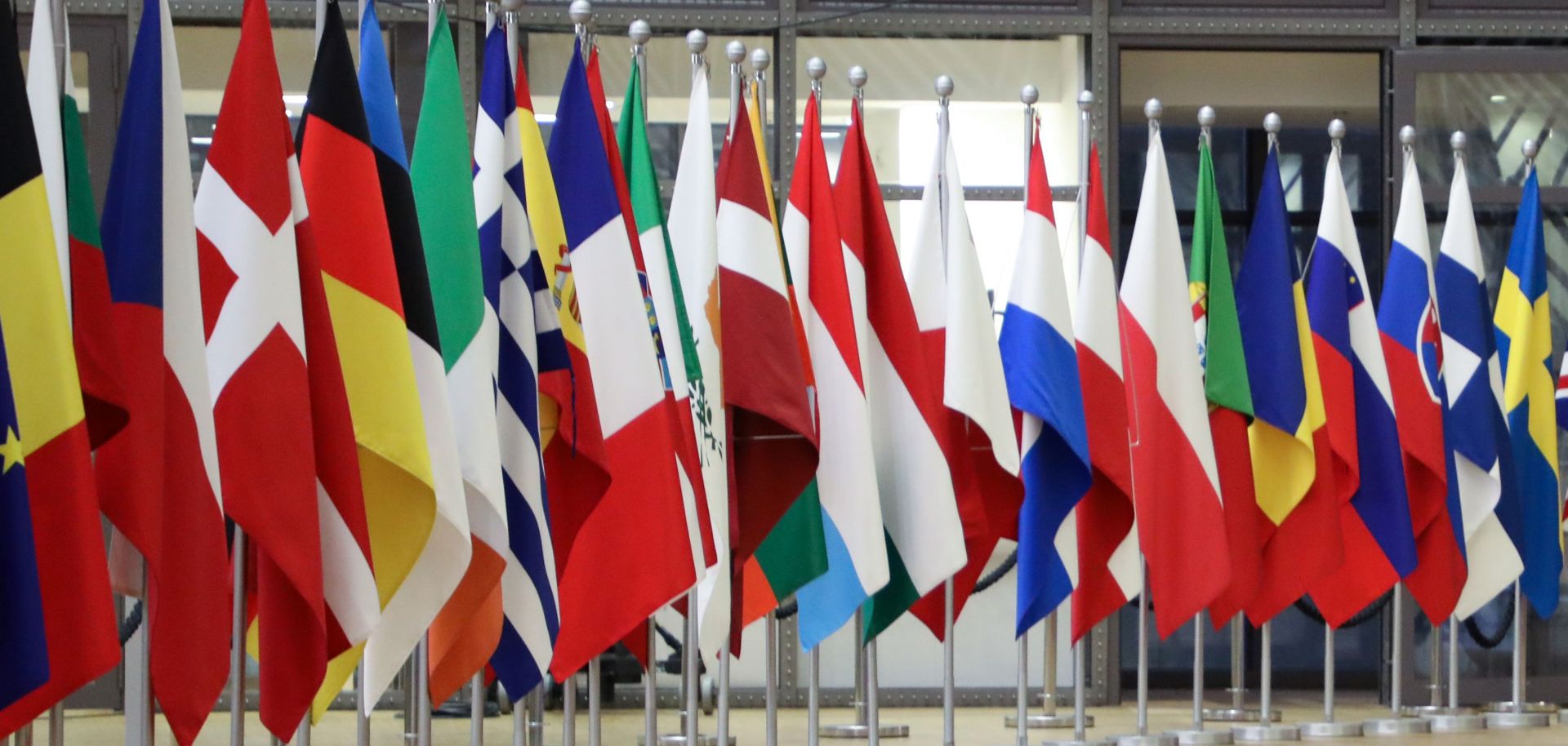 The national flags of the European Union’s 27 member states are seen in the European Council headquarters in Brussels, Belgium. 