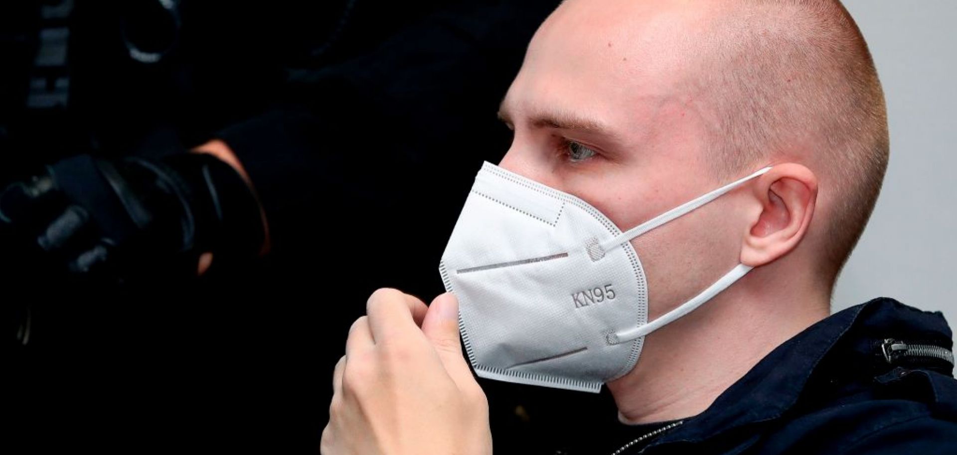 Stephan Balliet, who is accused of shooting two people dead after an attempt to storm a synagogue in Halle an der Saale, eastern Germany, wears a face mask as he waits for the start of the 18th day of his trial on Nov. 3, 2020, at the district court in Magdeburg, eastern Germany.