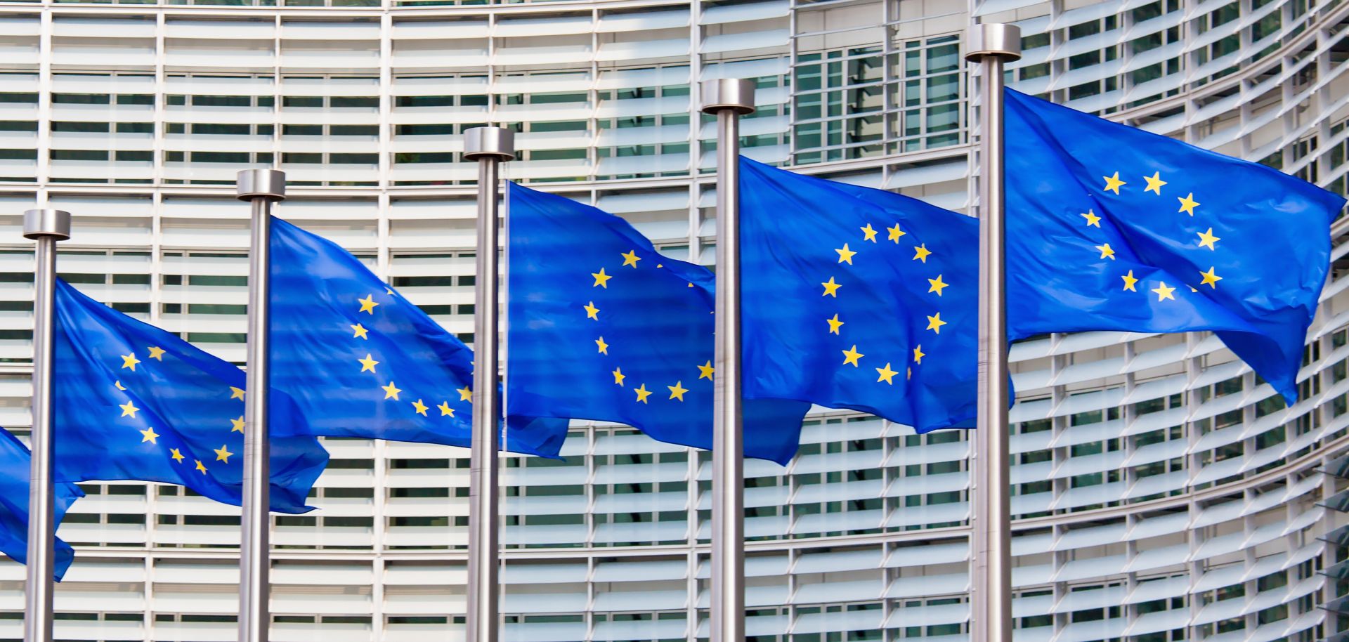 EU flags are seen waving in the wind. 