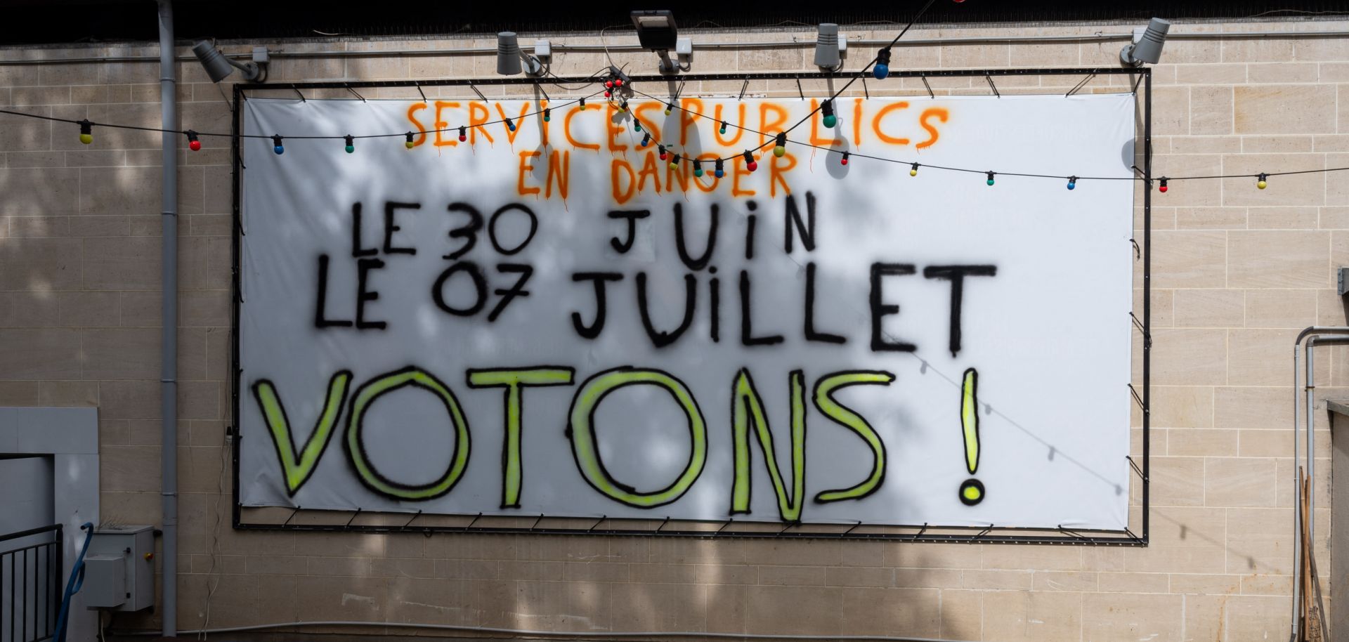 A banner reading "public services in danger, let's vote" on July 5 in Paris.