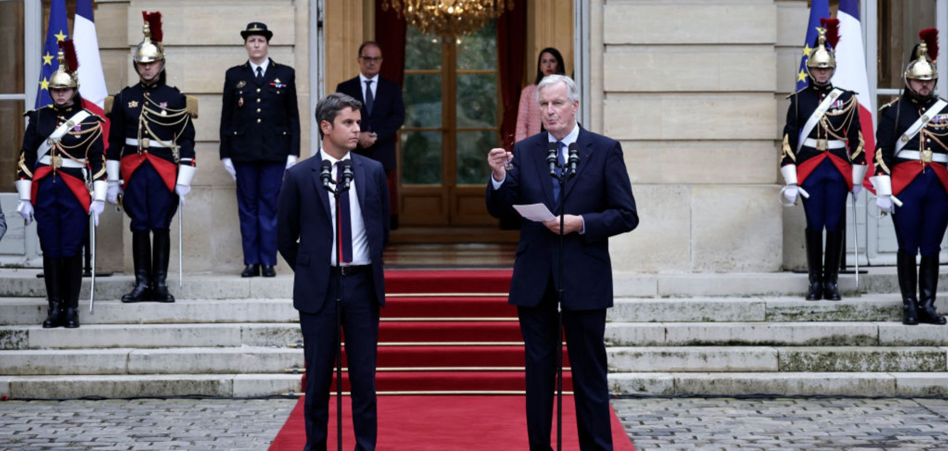 Incoming Prime Minister Michel Barnier (R) delivers a speech next to outgoing Prime Minister Gabriel Attal on Sept. 5 in Paris.